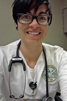 Andrea tries on her official nursing school uniform.