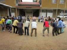  Peace Corps volunteers and Tanzanians partake in an exercise that teaches HIV prevention.
