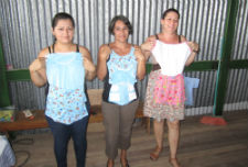 Members of the women's group in Costa Rica holding hand sewn products.