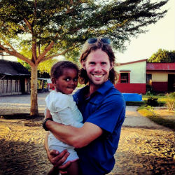 Peace Corps volunteer Patrick Spencer with a child in Madagascar.