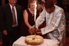 Peace Corps Country Director Michael J. Simsik looks on as His Excellency Amadou Toumani Toure and U.S. Amb. Gillian Milovanovic cut the Peace Corps 50th Anniversary cake.
