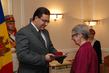 Moldova Acting President and Speaker of Parliament Marian Lupu presents the Order of Honor to Acting Peace Corps Country Director Margaret Molinari.