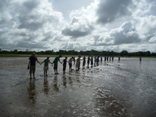 Peace Corps Volunteers and their counterparts measure the planting site