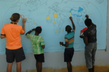 Volunteer John Williams paints with his students