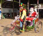 Photo of Santa riding in a rickshaw