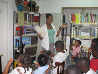 Owens reads to children during story time at the library.