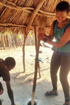 My host siblings are teaching me how to pound mahangu. It's a lot hard than it looks.