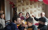 Julia eating and celebrating with her host family