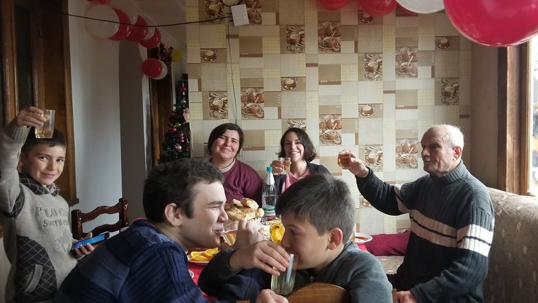 Julia eating and celebrating with her host family