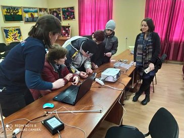 Julia teaching three students with her counterparts