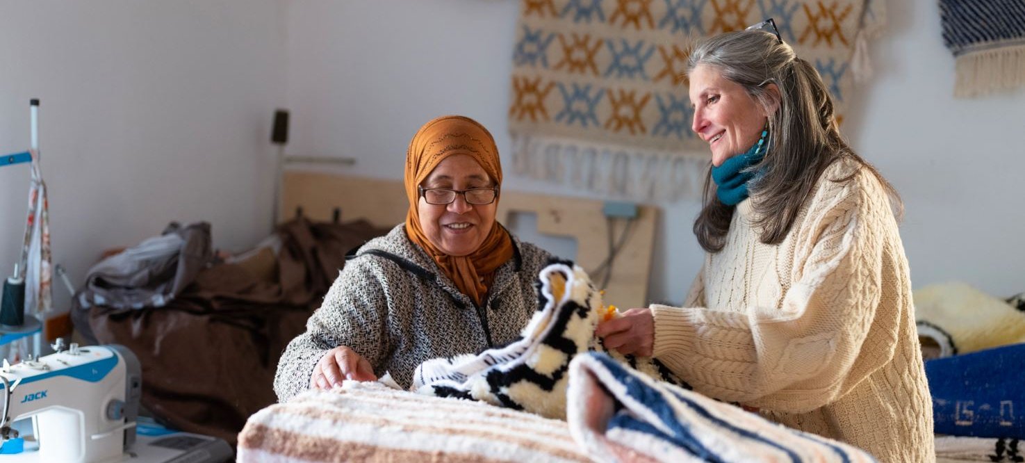 Two women looking at quilts