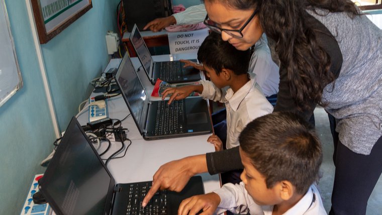 Volunteer teaching computer skills to students