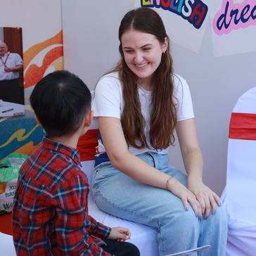 Sophia practices English with children at the America-Viet Nam friendship festival.