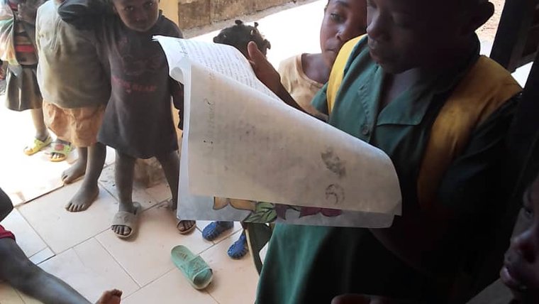 Children in Cameroon reading the books created by students in California