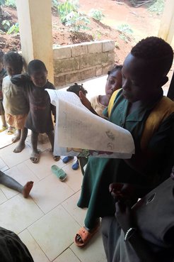 Children in Cameroon reading the books created by students in California
