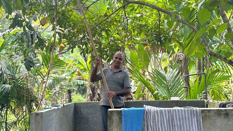 Katie’s host dad harvests rambutan in Sri Lanka.