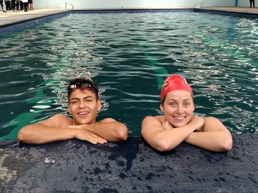 Brenna works with a student from her assigned community in a swimming class to promote physical activity and healthy habits in the local school.
