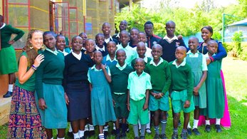 Deaf Education Volunteer Savannah Posing with Her Students in Kenya
