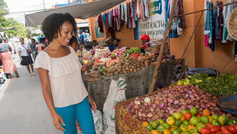 A Peace Corps Volunteer shops at a market in the Dominican Republic