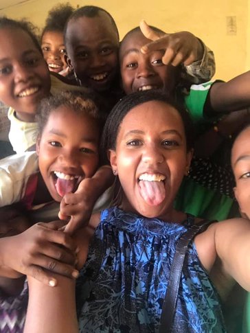 A group of people smile in Madagascar