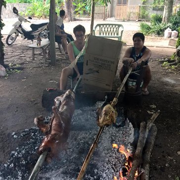 Roasting a lechon baboy (roast pig) with host cousin Jordon, who roasts a turkey