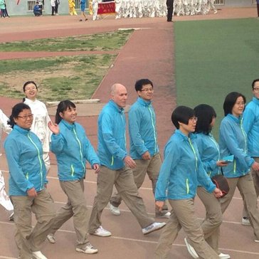 Lawrence Kahn marches in a Sports Day celebration with members of the English department at his university site in Lanzhou.