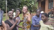 Health Volunteer Emma celebrates her return to Malawi with her community by dancing