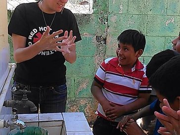 Allyson with kids of the school.
