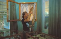 Pat Cotter hanging a preserved lobster in museum