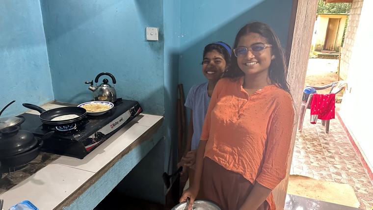Katie makes pancakes with her host sisters in Sri Lanka.