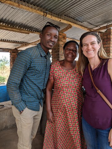 Kait standing with two people from the Shining Coffee company in Rwanda