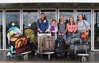 Five Response Volunteers stand infront of the Lilongwe airport with their luggage