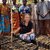 Ashley poses with a tree nursery group and their seedlings