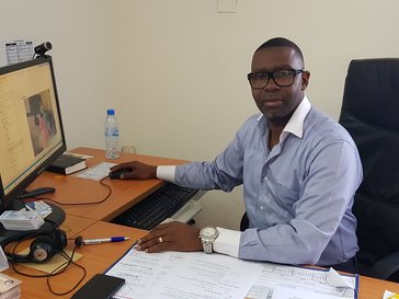Person sitting in front of computer in office
