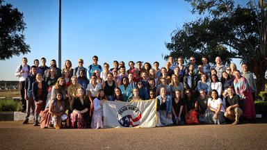 Group of Peace Corps Trainees with Peace Corps flag