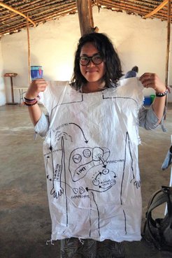 A Trainee holds a diagram of the malaria virus lifecycle.