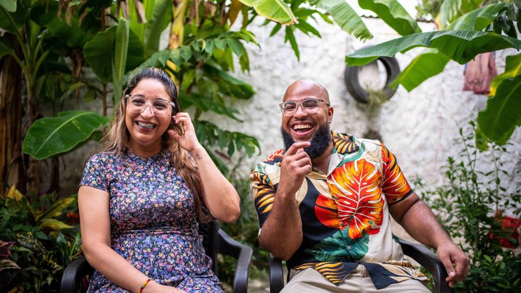 Peace Corps Volunteer David enjoys a laugh with a member of his host family in Colombia.