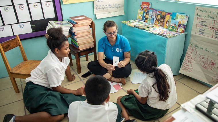 Peace Corps Response Brandi with three students during a small group learning.