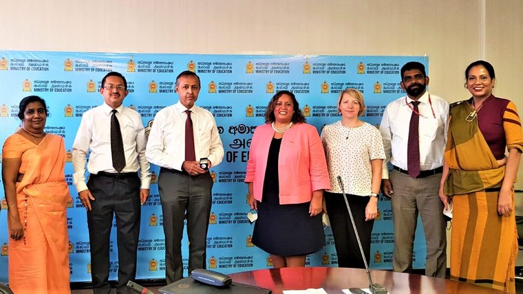 Peace Corps officers including the Country Director posing for a picture with Secretary to the Ministry of Education