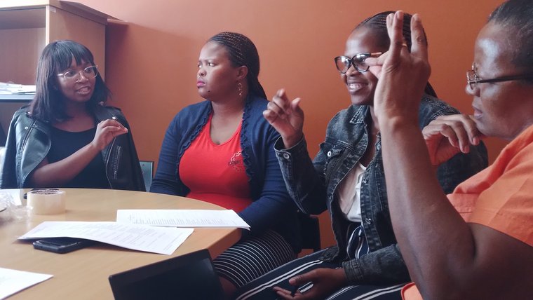 Nurses Siniketiwe, Thobile, and Phindile collaborate on translation of health videos in Eswatini.