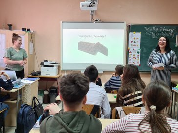 Volunteer Brooke is co-teaching English class with her local counterpart
