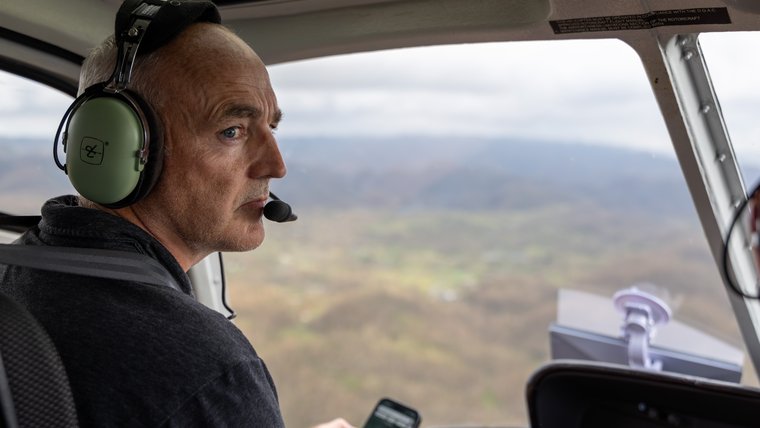 John looks out over the damage to western Jamaica on the flight to his Peace Corps community
