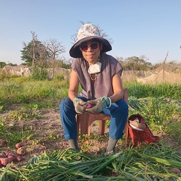 Tracy gardens in her counterpart's field.