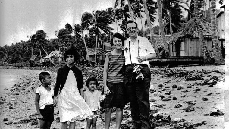 A Volunteer in 1964 stands with her visiting father in the Philippine village.