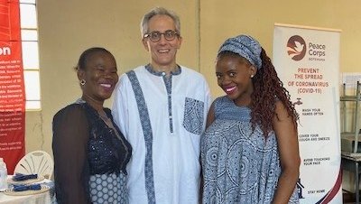 White man stands between two black women