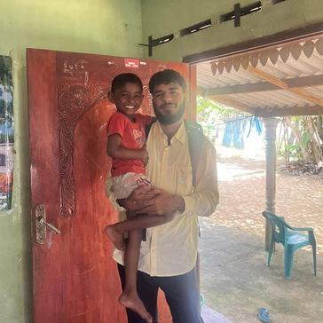 Rohan holds his host brother Tachu in Sri Lanka.
