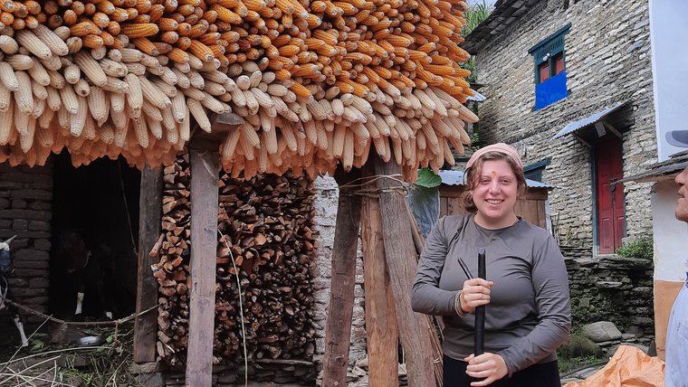 Peace Corps Volunteer Kindness H. in front of a project.