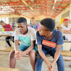 Students in Namibia sit at a table