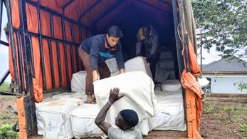 loading a truck with malaria nets