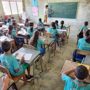 Volunteer teaches children in classroom